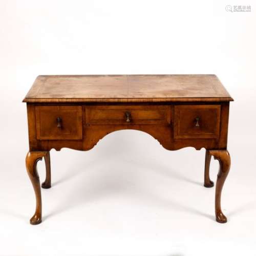 A walnut kneehole dressing table, fitted three drawers on cabriole legs,