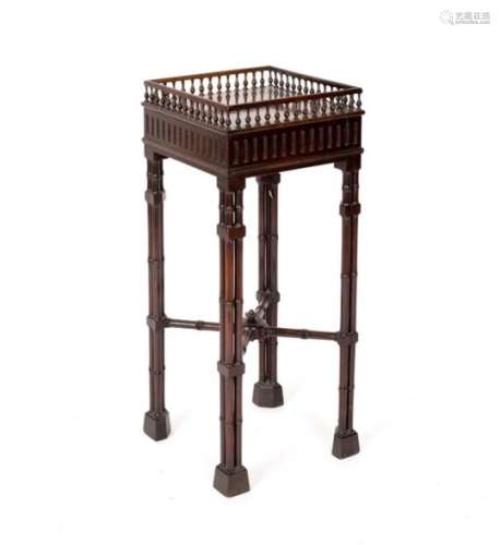 A Chippendale style mahogany square jardinière stand with gallery and raised on cluster column