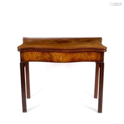 A George III serpentine front card table, on fluted carved square legs,