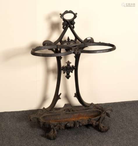 A cast iron umbrella stand with pierced decoration, division and base,