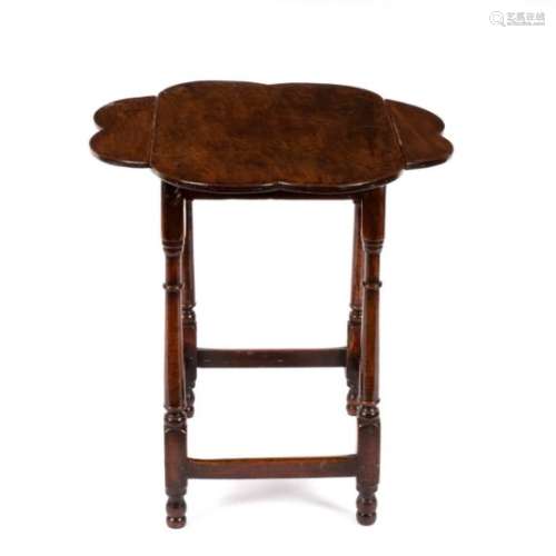 A George III mahogany two-flap octofoil table with rectangular frieze on ring-turned tapered legs