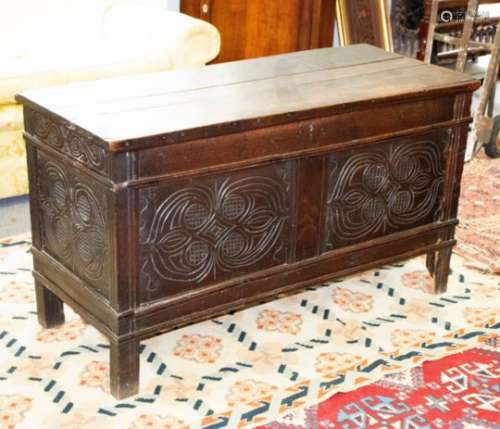17th Century oak coffer with decorative carved panels to the front and sides,