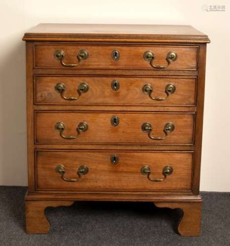 A narrow mahogany chest of four drawers on bracket feet,