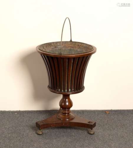 A 19th Century mahogany jardinière stand of urn form on a platform base,