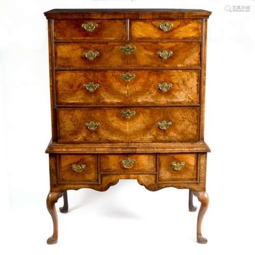 A George I walnut chest fitted two short over three long drawers on a later three drawer stand, 98.