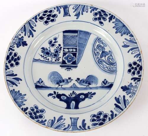 A late 18th Century blue and white English Delftware dish decorated a cock fighting scene,