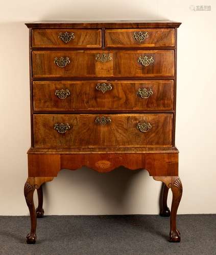 An early 18th century figured walnut and herringbone banded chest on stand,