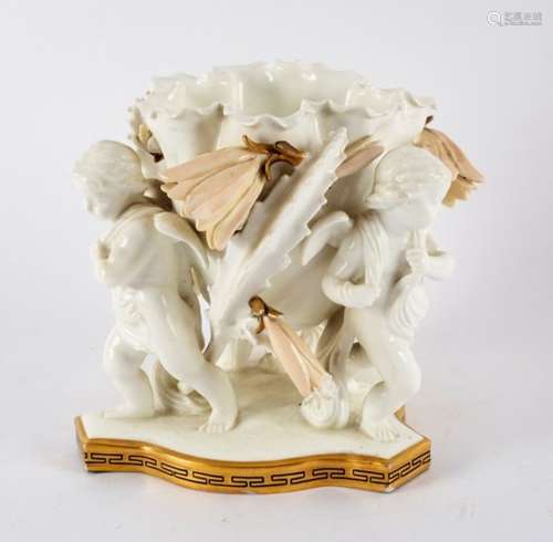 A Moore porcelain centrepiece modelled as a flowerhead on three cherub supports,