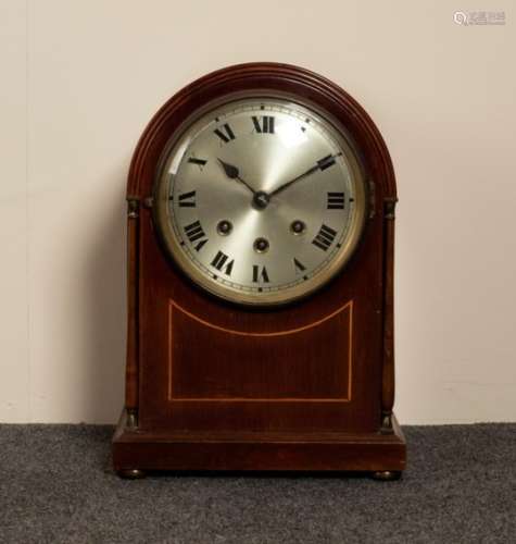 A mahogany arch-top mantel clock with eight-day chiming movement,