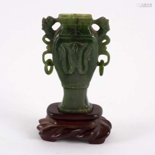 A Chinese spinach jade urn of square baluster section with scrolling ring handle and dragon carving,