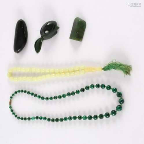 A collection of Maori moss agate figures, a beaver, a turtle, a malachite bead necklace,