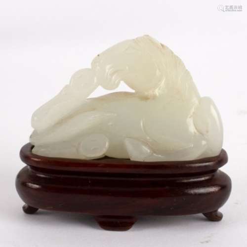 A Chinese white jade carving of a recumbent horse, 18th/19th Century,