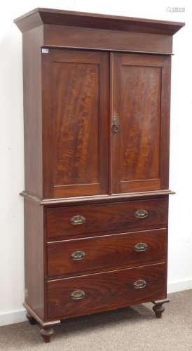 Early 20th century scumbled pine cupboard on chest, projecting cornice over two paneled doors,
