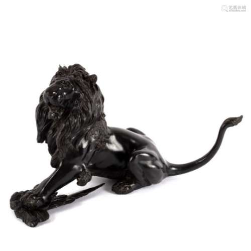 A Japanese bronze figure of a lion, his prey under his left paw, signed,