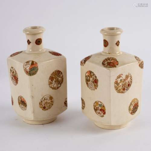 A pair of Japanese Satsuma square section bottle vases painted with circular panels of flowers,
