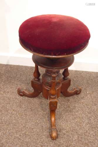 Victorian walnut revolving piano stool, rise and fall seat upholstered in red velvet,