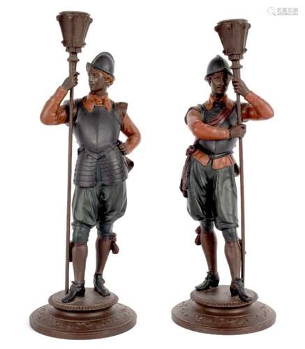 A pair of figural candlesticks, the supports in the form of pike men,