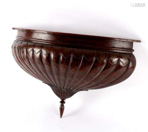 A carved walnut canopy finial of reeded coronet form,