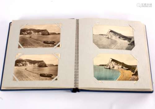 An early 20th Century postcard album of approximately 100 cards,