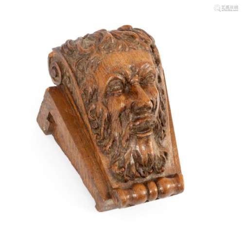 A mask head carving of a bearded man on a scrolling mount, 29.