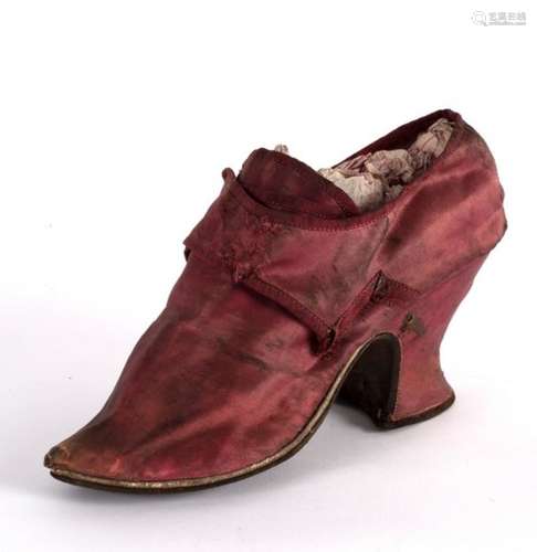 An 18th Century single silk crimson shoe with leather sole,