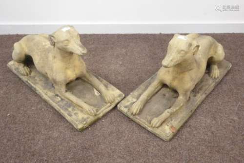 Pair composite stone recumbent dogs,
