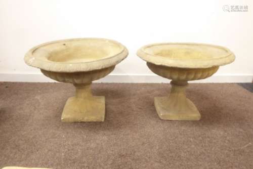 Three composite stone urn planters, circular form with egg and dart rim and gadroon underside,