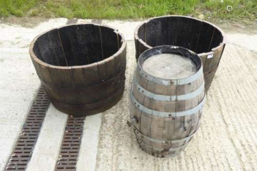 Pair of half cut iron bound whisky barrel planters,