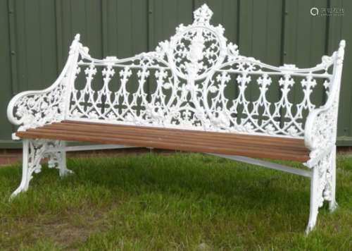 Coalbrookdale style white painted cast metal garden bench with teak slats and central shield motif,