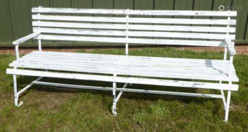 White painted wrought metal bench, with slatted back and seat,