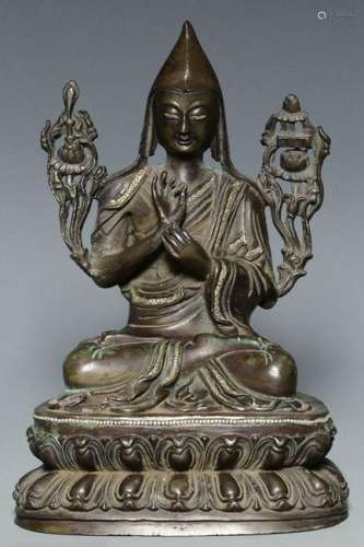 A QING DYNASTY SILVER-INLAID BRONZE FIGURE OF LAMA