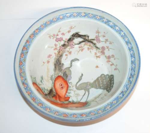 A CANTONESE BOWL the well painted with a peacock and hen amongst blossoming trees and rockery,