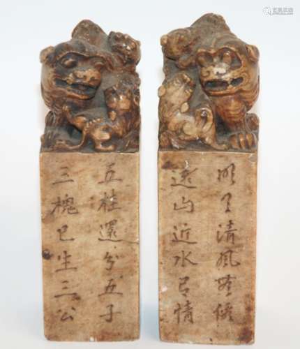 A PAIR OF CHINESE SOAPSTONE SEALS each carved with a shishi and cubs astride pillars with