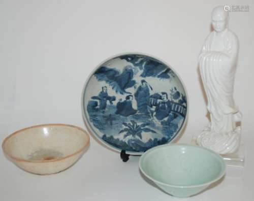 A CHINESE BLUE AND WHITE DISH painted with figures in a garden, 21.5cm diameter, two incised