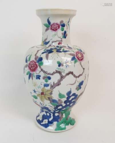 A CHINESE BALUSTER VASE painted with peonies and hibiscus issuing from blue and green rockwork,