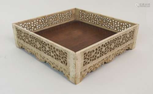 A RARE CHINESE MARINE IVORY AND HUANGHUALI SQUARE TRAY the sides finely carved with foliate