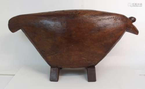 AN AFRICAN HARDWOOD ANIMAL FORM DRUM the broad tapering body on bracket feet, 41cm high and 84cm