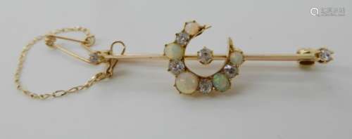 AN OPAL AND DIAMOND CRESCENT MOON BROOCH largest opal approx 4.3mm, diamonds estimated approx 0.