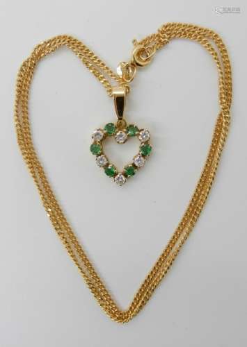 AN 18CT GOLD EMERALD AND DIAMOND HEART SHAPED PENDANT set with six brilliant cut diamonds with an