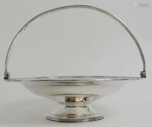 A VICTORIAN SILVER SWING HANDLED BASKET by Robert Harper, London 1869, of circular form with