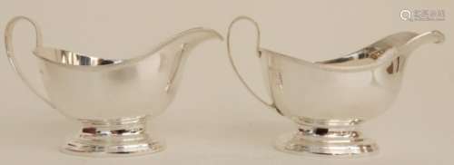 A CASED PAIR OF SILVER SAUCEBOATS by Henry Clifford Davis, Birmingham 1963, of classic plain shape