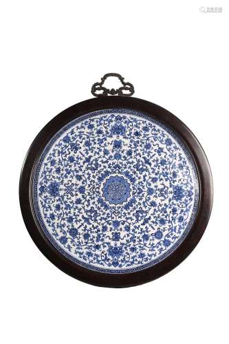 A LARGE BLUE AND WHITE CIRCULAR HANGING PANEL