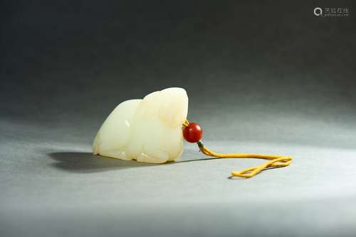 A WHITE JADE CARVING OF DEER GRASPING LINGZHI