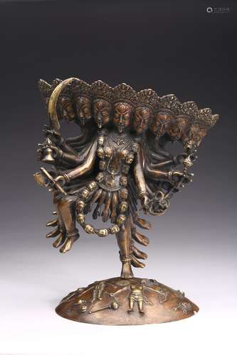 A BRONZE FIGURE OF STANDING TIBETAN DEITY