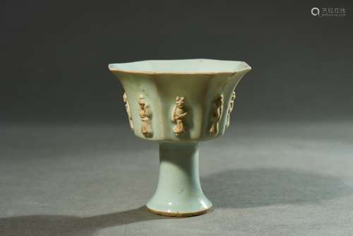 A WHITE GLAZED MOULDED 'FIGURE' CUP