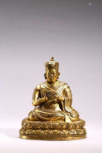 A GILT BRONZE FIGURE OF SEATED PANCHEN LAMA