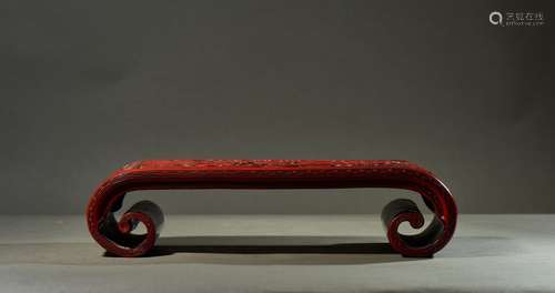 A CINNABAR LACQUER 'BOOK SCROLL' BRUSH REST