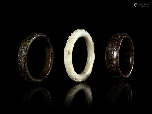 Three Carved Hardstone Bangles Largest: diam 2 1/2 diam