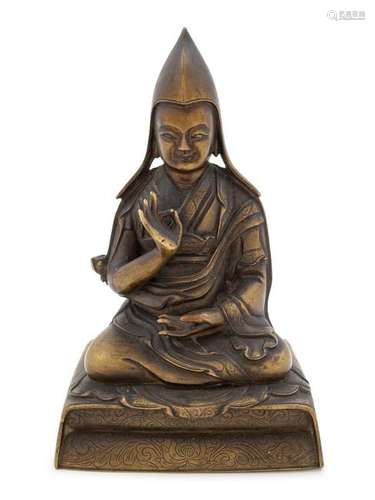 A Sino-Tibetan Gilt Bronze Figure of a Lama Height 5