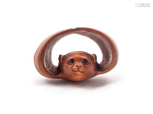 A Japanese Carved Boxwood Netsuke Length 1 3/4 in., 4.5